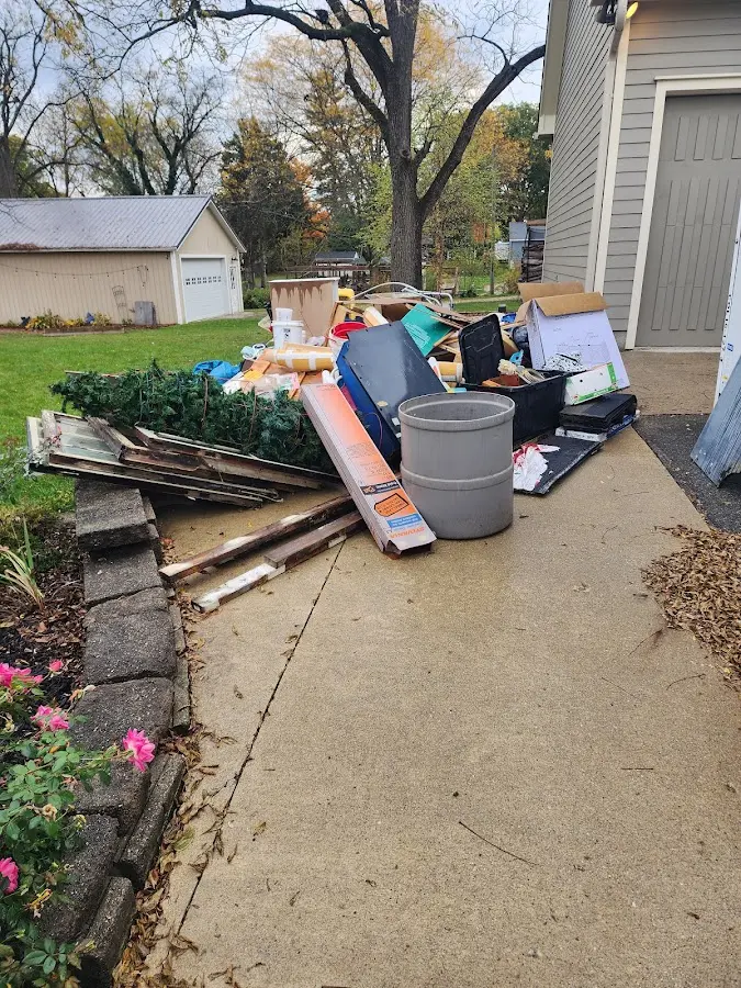 Dumpster being loaded with debris for 12 Yard Dumpster Rental in Friendship Heights Village